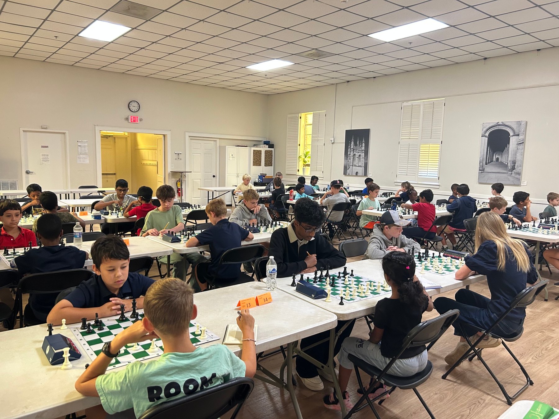 Young players competing across the Marietta Stonehaven scholastic tournament room.